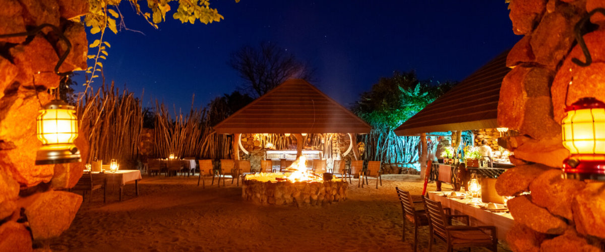 Open air boma dinner around blazing fire-pit at Leopard Hills Lodge.