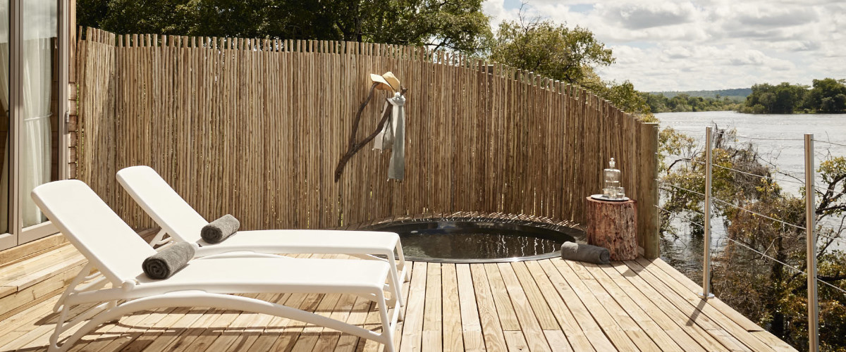 Wooden deck with sun loungers and private plunge pool with panoramic Zambezi River views.